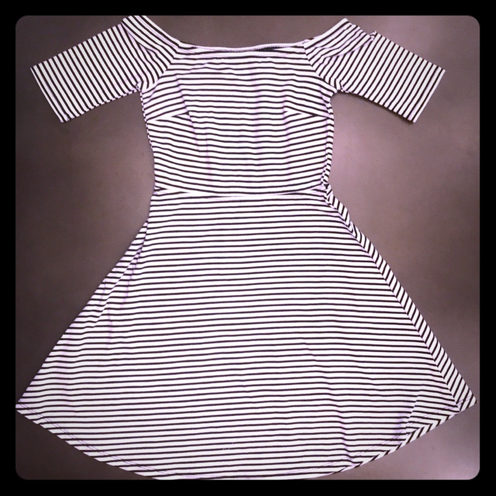 An off the shoulder black and white striped dress.